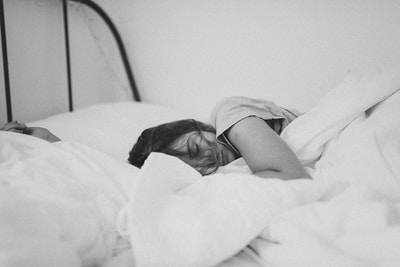 sick woman sleeping in bed